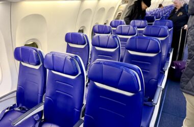 a row of blue seats on an airplane