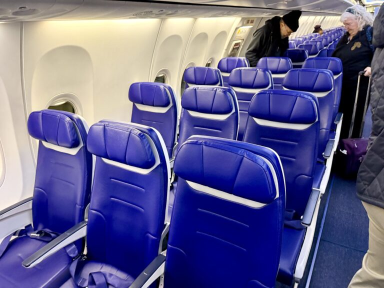 a row of blue seats on an airplane