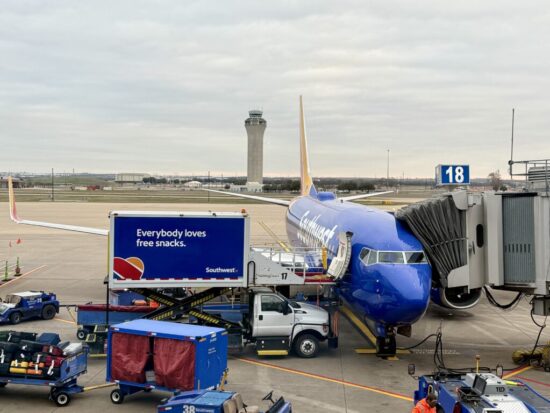 a blue airplane on a runway