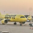 a yellow airplane on a runway