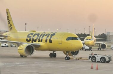 a yellow airplane on a runway