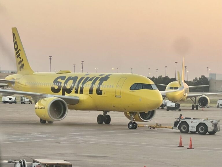 a yellow airplane on a runway