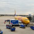 a yellow airplane at an airport