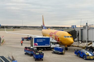 a yellow airplane at an airport