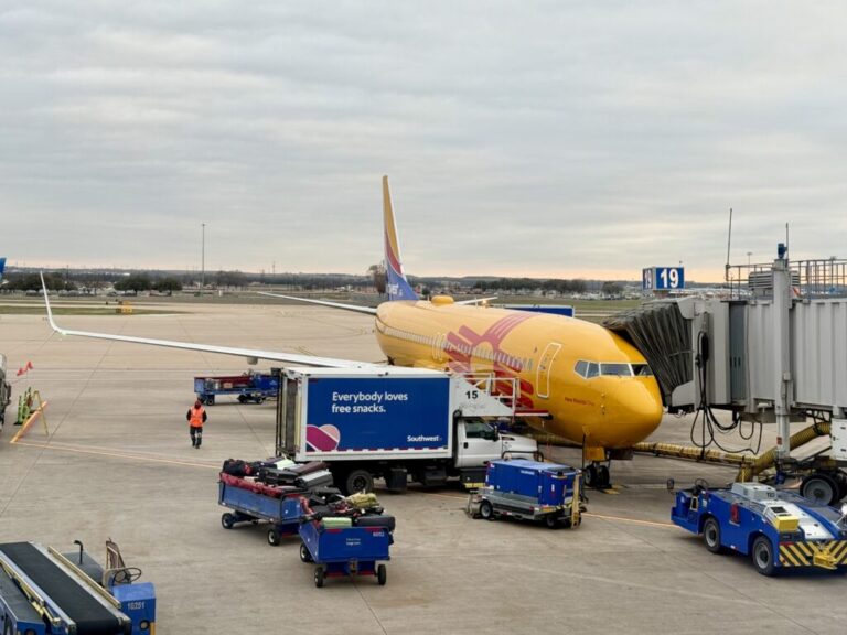 a yellow airplane at an airport