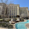 a building with a pool in front of it