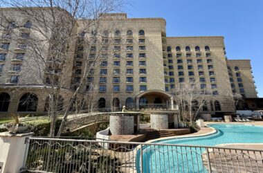 a building with a pool in front of it