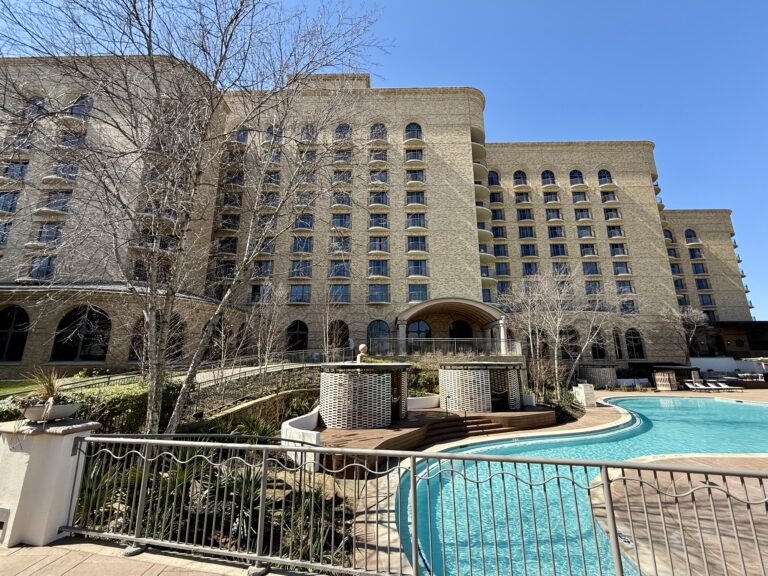 a building with a pool in front of it