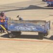 a man pushing a blue cart