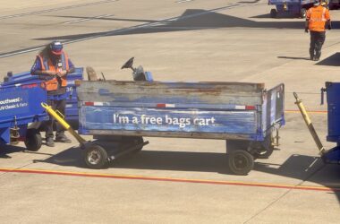 a man pushing a blue cart