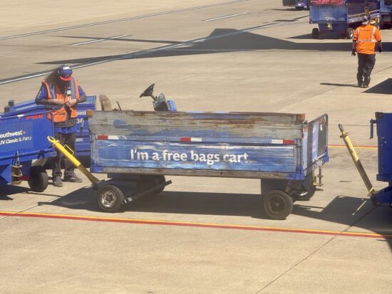 a man pushing a blue cart