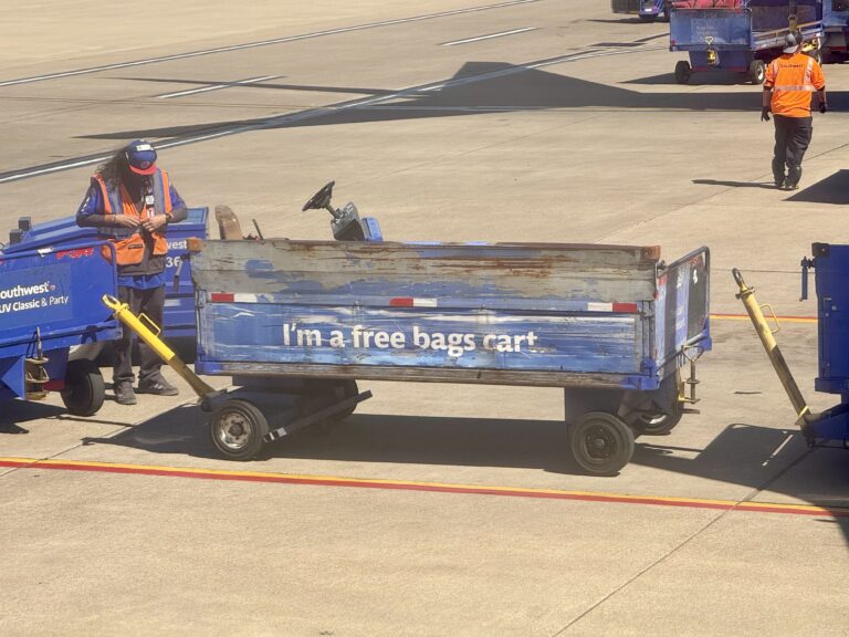 a man pushing a blue cart