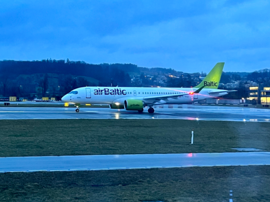 a white airplane on a runway