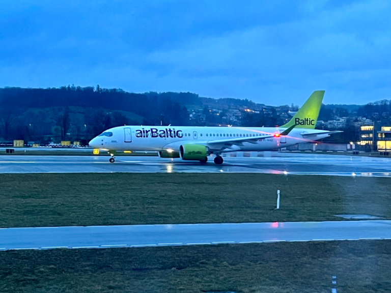a white airplane on a runway