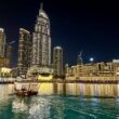a boat in a body of water with buildings in the background