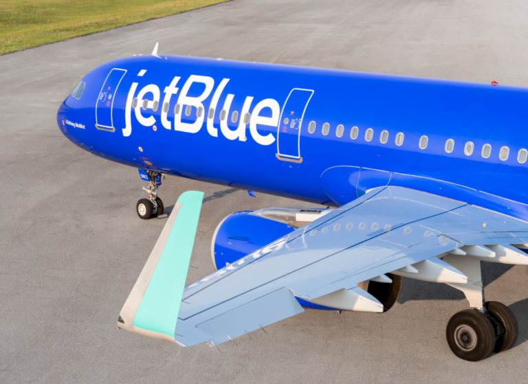 a blue airplane on a runway
