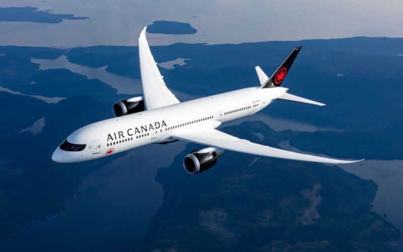 a white airplane flying in the sky