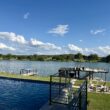 a pool with a dock and a body of water