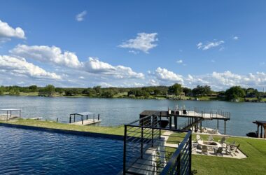 a pool with a dock and a body of water