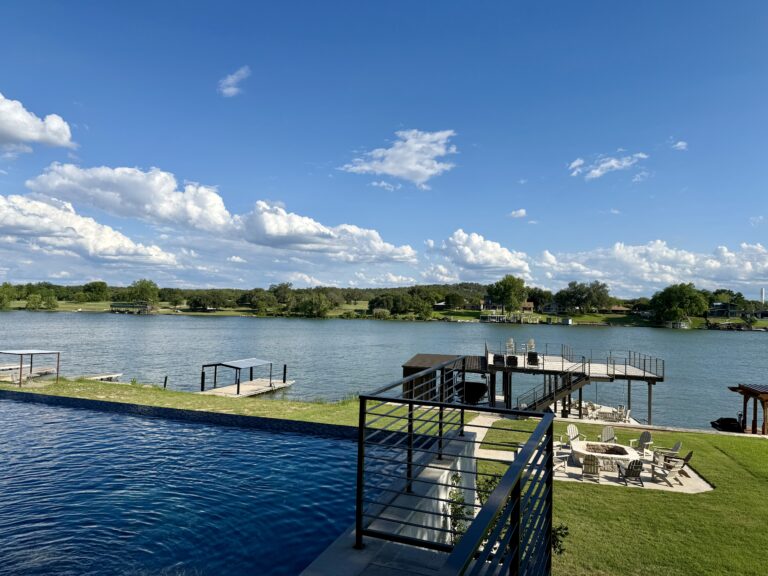a pool with a dock and a body of water