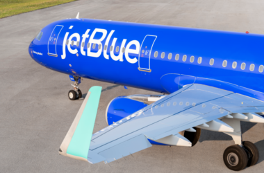 a blue airplane on a runway