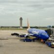 a blue airplane on a runway
