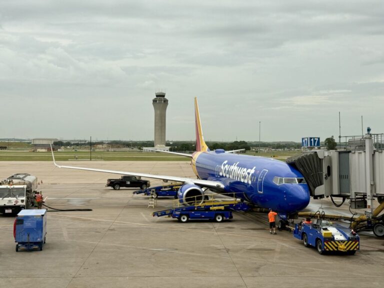 a blue airplane on a runway