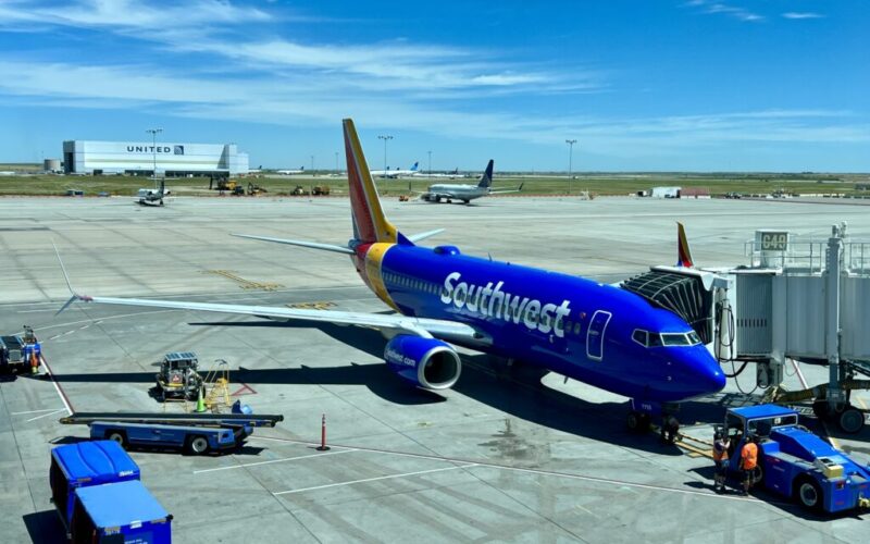 a blue airplane on a runway