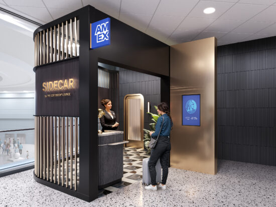a woman standing in front of a black and gold booth