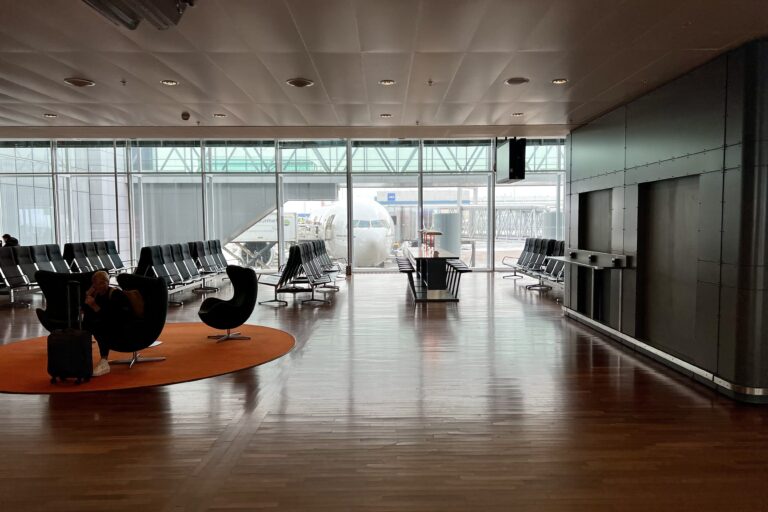 a room with chairs and a plane in the background