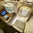 a seat with a table and a shelf in the back