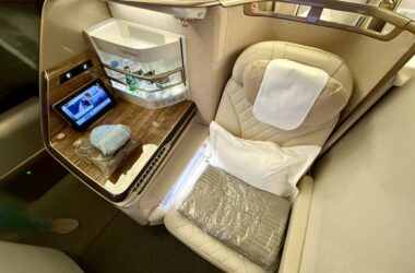 a seat with a table and a shelf in the back