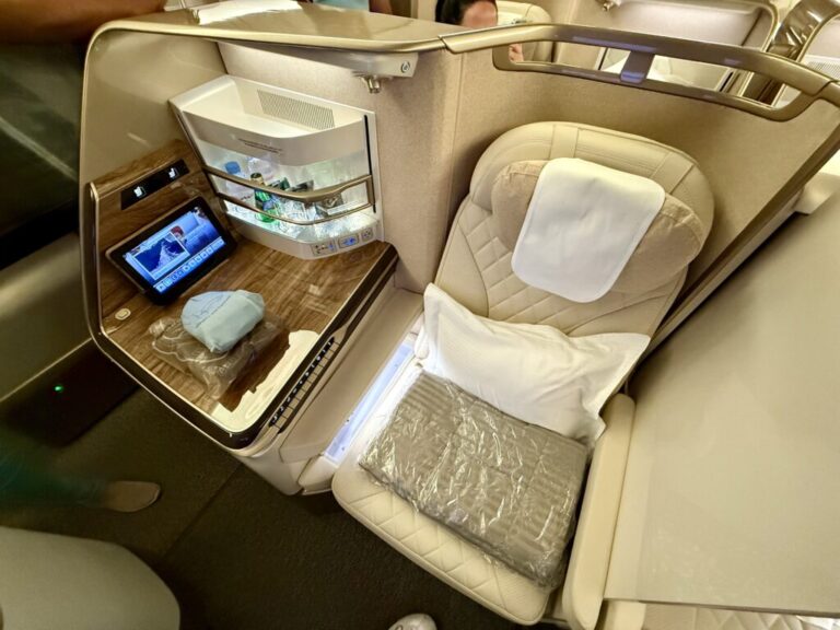 a seat with a table and a shelf in the back