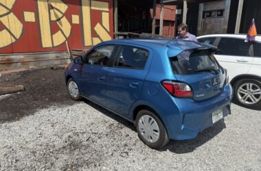 a blue car parked in front of a building