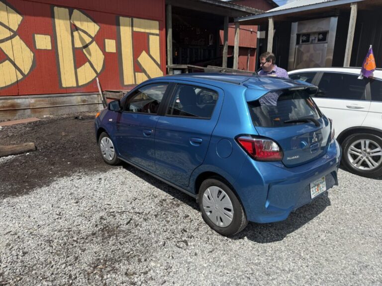 a blue car parked in front of a building