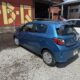 a blue car parked in front of a building