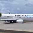 a white airplane on a runway