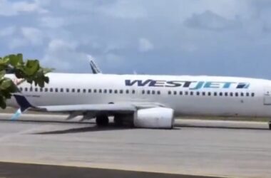 a white airplane on a runway