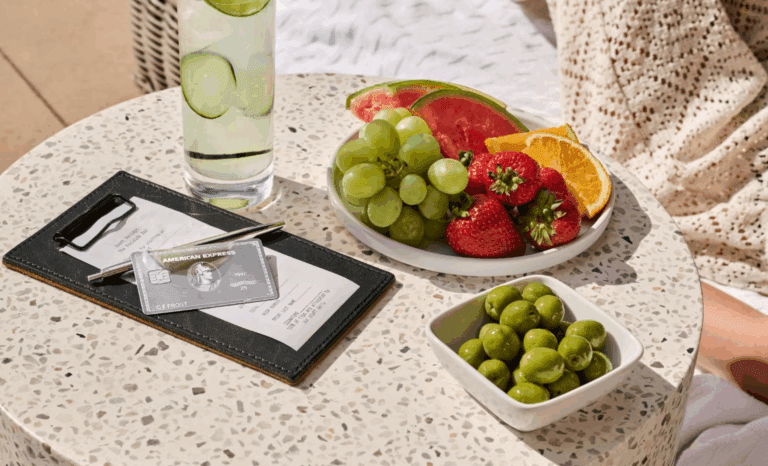 a plate of fruit and a glass of water next to a drink
