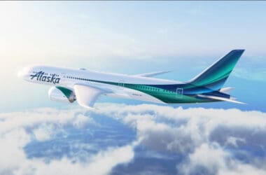 a white and green airplane in the sky