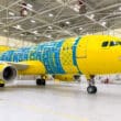 a yellow and blue airplane in a hangar