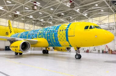 a yellow and blue airplane in a hangar