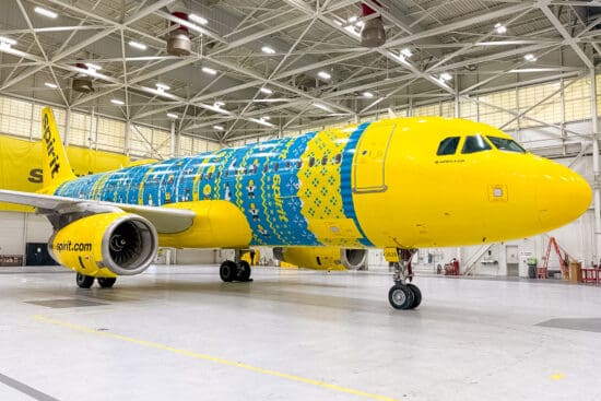 a yellow and blue airplane in a hangar