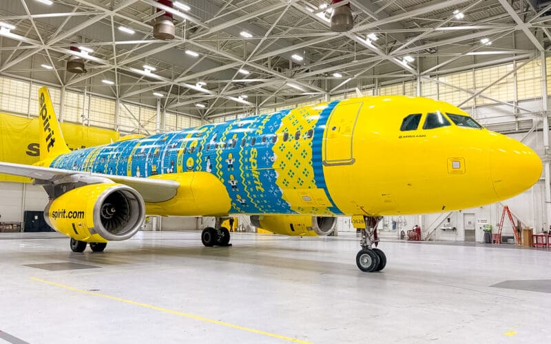 a yellow and blue airplane in a hangar