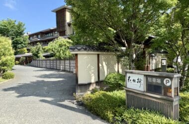 a road with trees and a building
